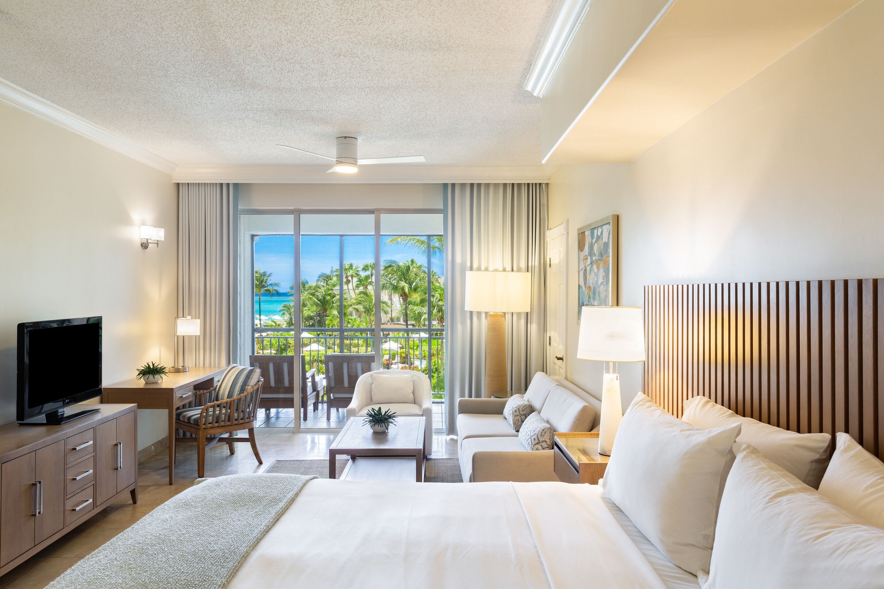 junior suite, garden view | in-room safe, desk, blackout curtains, iron/ironing board