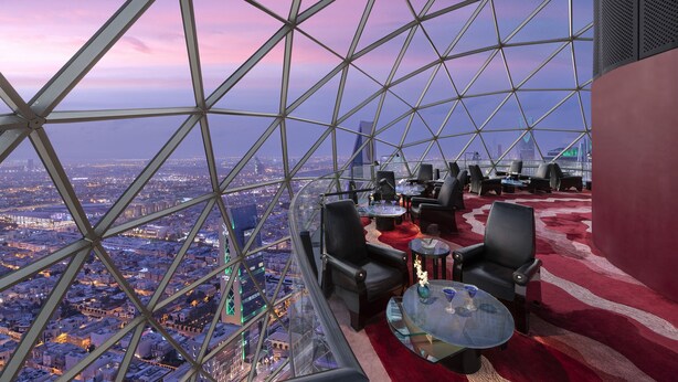 A high-rise observation deck with a panoramic city view, furnished with leather chairs and tables, and a red carpet. - Mandarin Oriental Al Faisaliah, Riyadh (Riyadh)