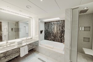 Un baño moderno con un espejo grande, dos lavamanos, una bañera y una zona de ducha.