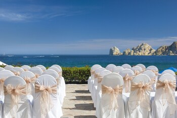 Enjoy the breathtaking ocean views from this seaside event space, featuring rows of elegant chairs leading to the shore. at Pueblo Bonito Los Cabos Blanco - All Inclusive
