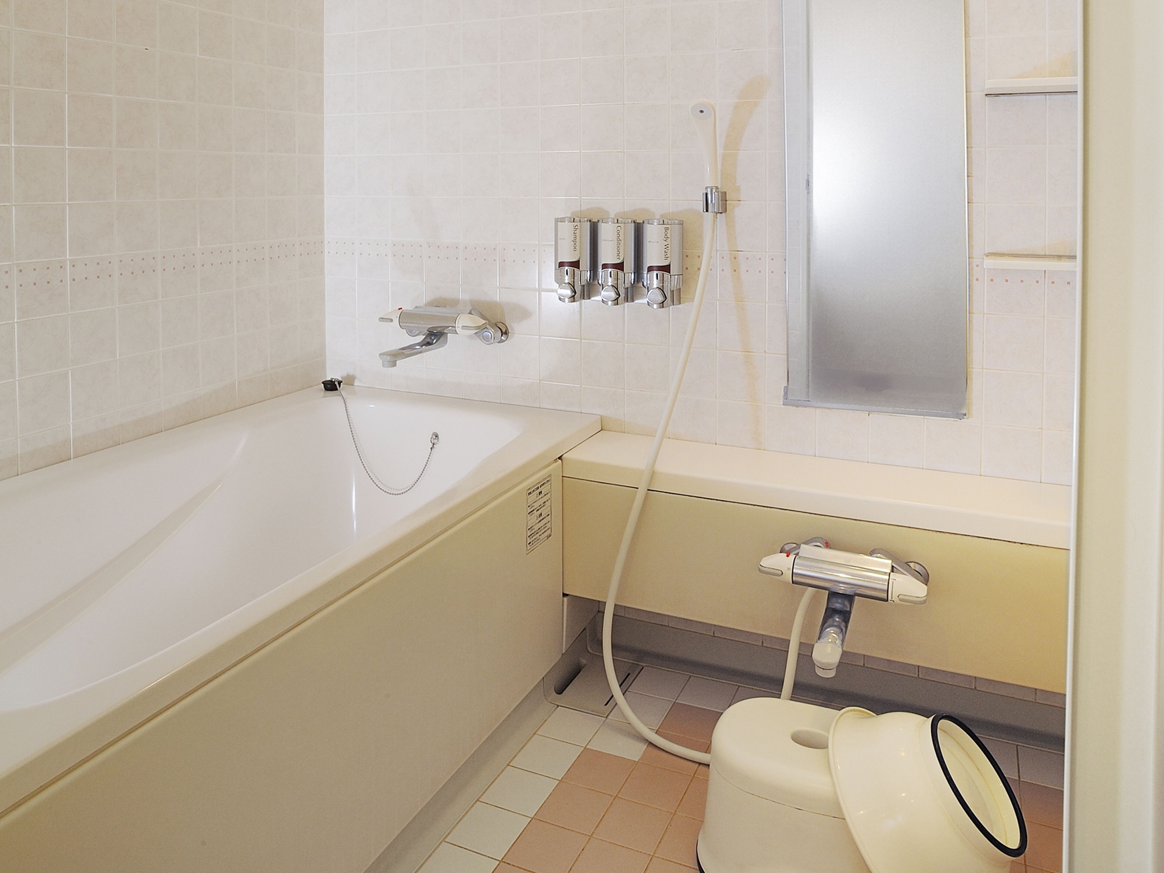 A bathroom with a bathtub, a toilet, and a sink.