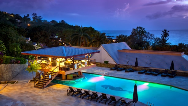 A pool area with lounge chairs and a covered seating area. - Le Grand Courlan Spa Resort - Adults Only (Black Rock)