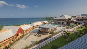 A resort with multiple buildings, a pool area, and a view of the ocean. - Le Grand Courlan Spa Resort - Adults Only (Black Rock)