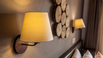 A wall-mounted lamp and a decorative log wall.