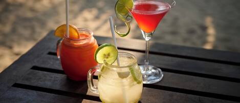 Three drinks on a wooden table.