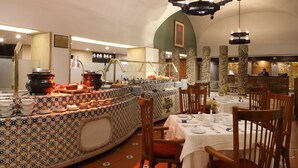 Un restaurante con servicio de buffet, que ofrece una variedad de platos y una barra con ollas de cocina.