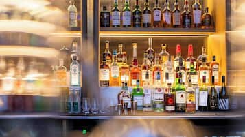 A bar with various bottles of alcohol and glasses.