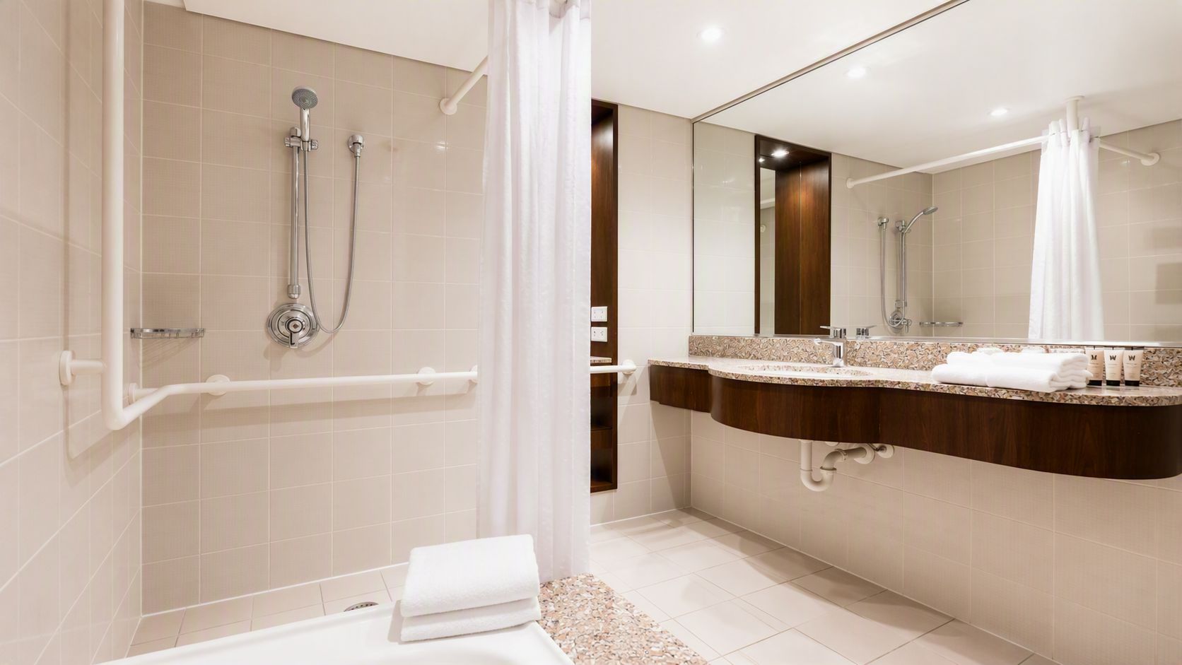 A modern bathroom with a walk-in shower, a bathtub, and a vanity with a mirror.