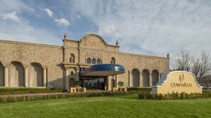 A historic building with a large entrance and a sign reading "Quinta Real".