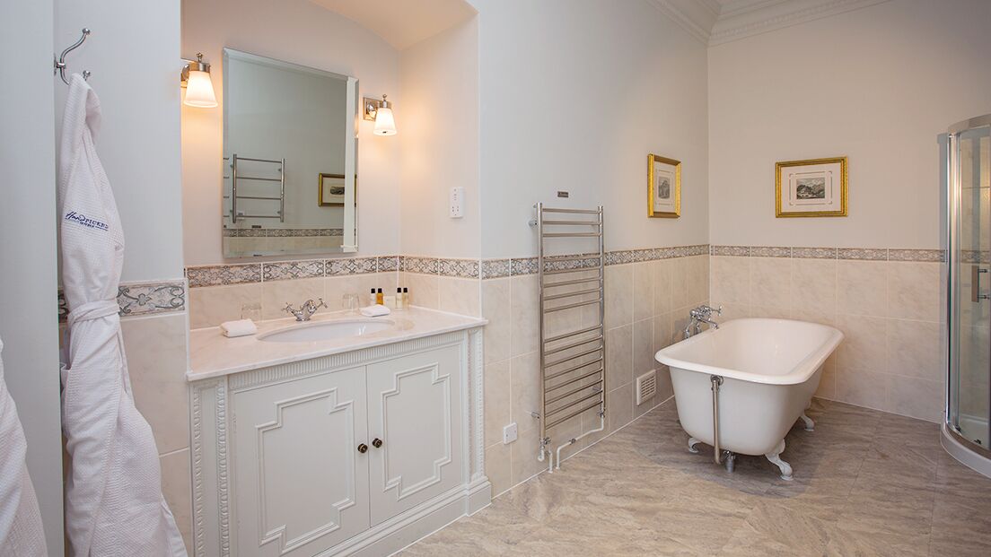 deluxe double room, 1 king bed | bathroom | separate bathtub and shower, free toiletries, hair dryer, slippers