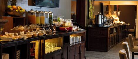 A buffet setup with various food items and beverages.