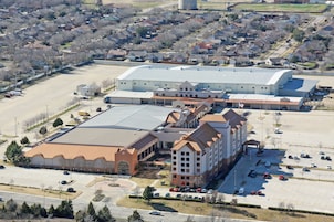 A large building with multiple parking lots and a central courtyard.