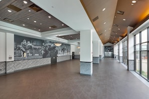 A spacious hallway with a high ceiling, large windows, and a mural on the wall. - Hampton Inn & Suites Dallas-Mesquite (Mesquite)