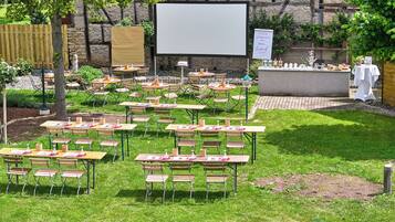 An outdoor seating area with tables and chairs arranged for guests.