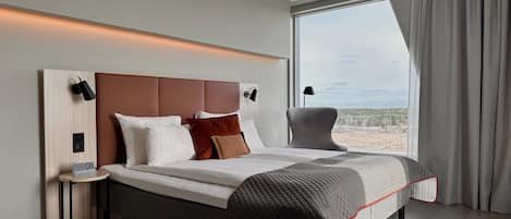 Hypo-allergenic bedding, desk, laptop workspace, blackout curtains