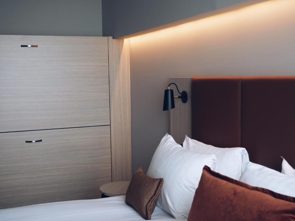 hypo-allergenic bedding, desk, laptop workspace, blackout curtains