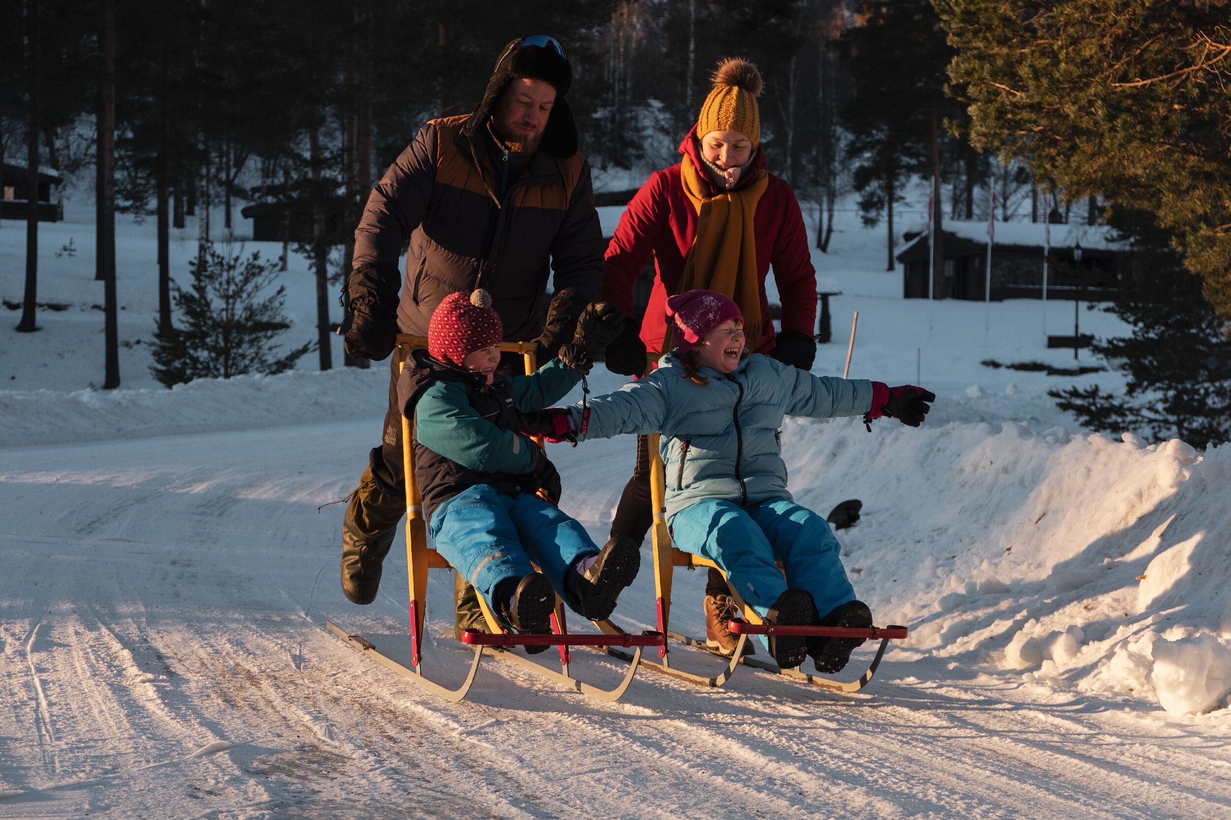 A group of people sledding on a snowy slope.