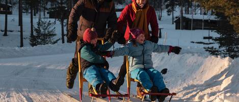 A group of people sledding on a snowy slope.