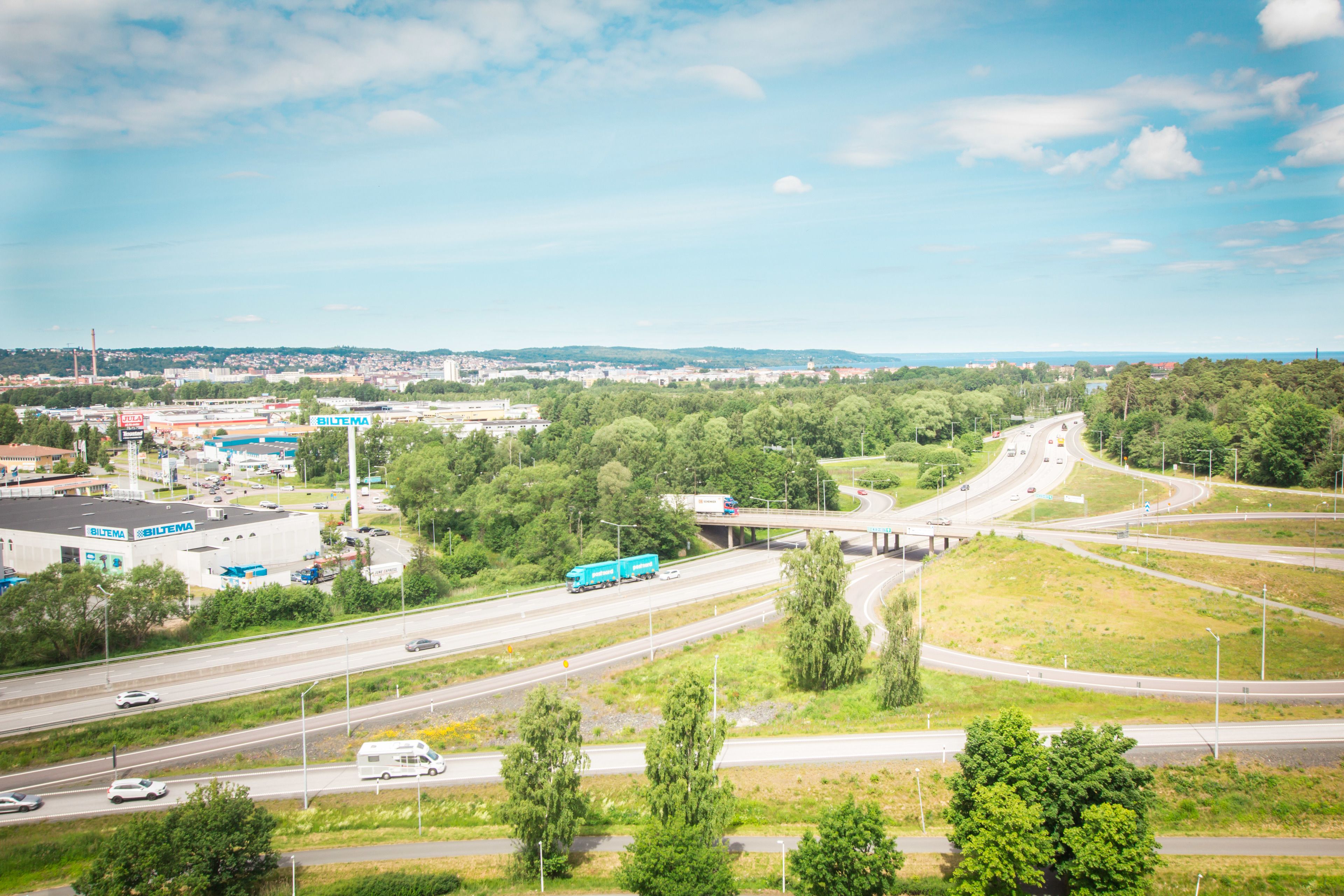 A highway interchange with multiple lanes and a bridge over a river.
