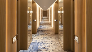 A hotel hallway with wooden paneling, numbered doors, and a patterned carpet. - Mövenpick Hotel Istanbul Bosphorus (Istanbul)