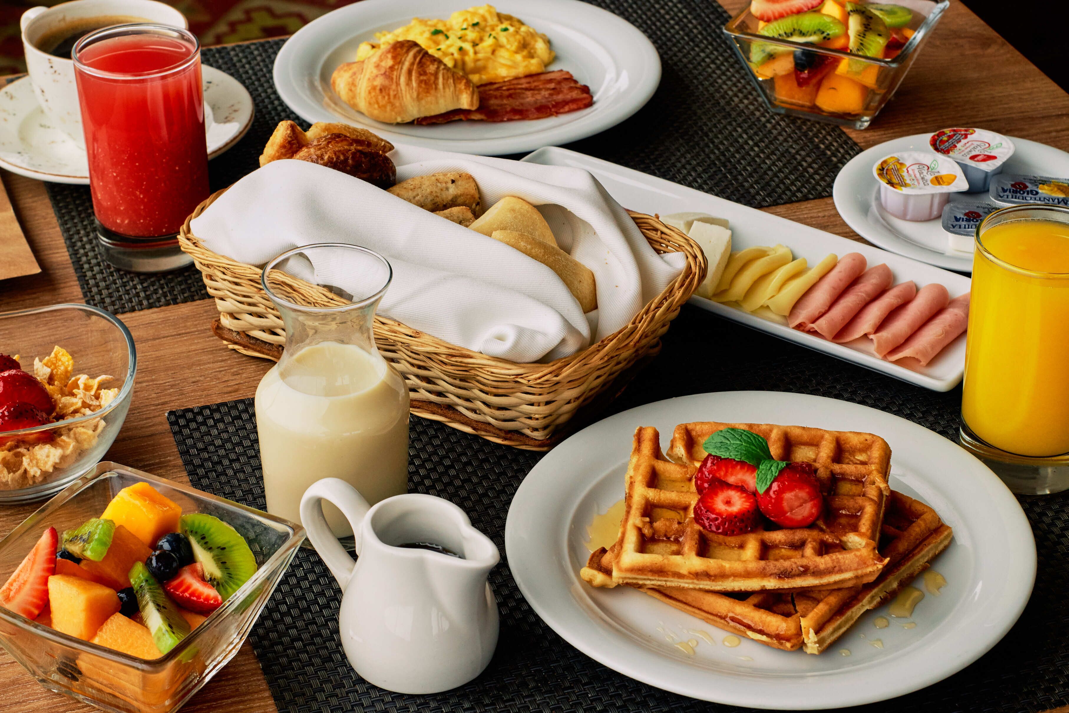 A breakfast buffet with various food items and beverages.