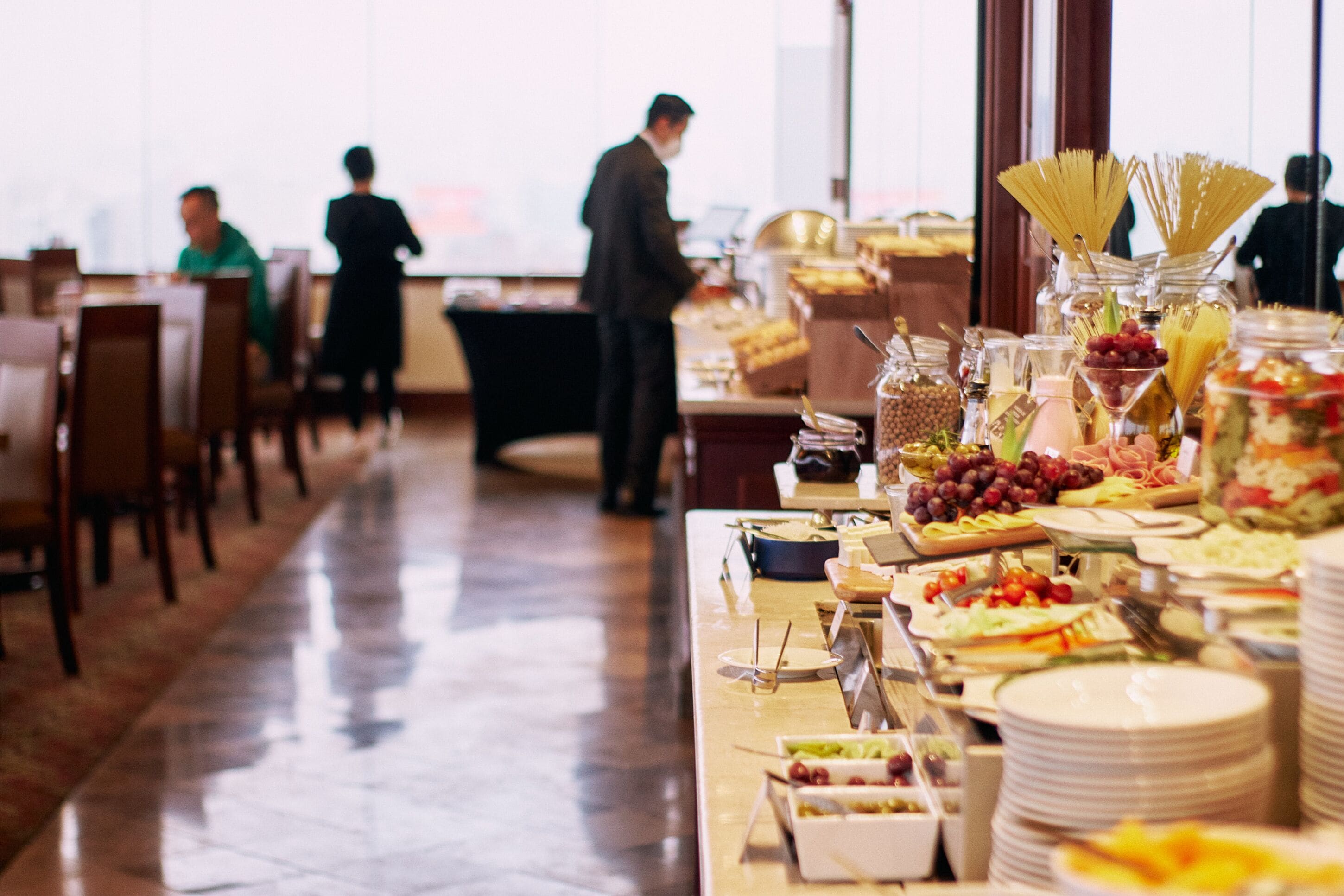 A buffet setup with various food items and utensils.