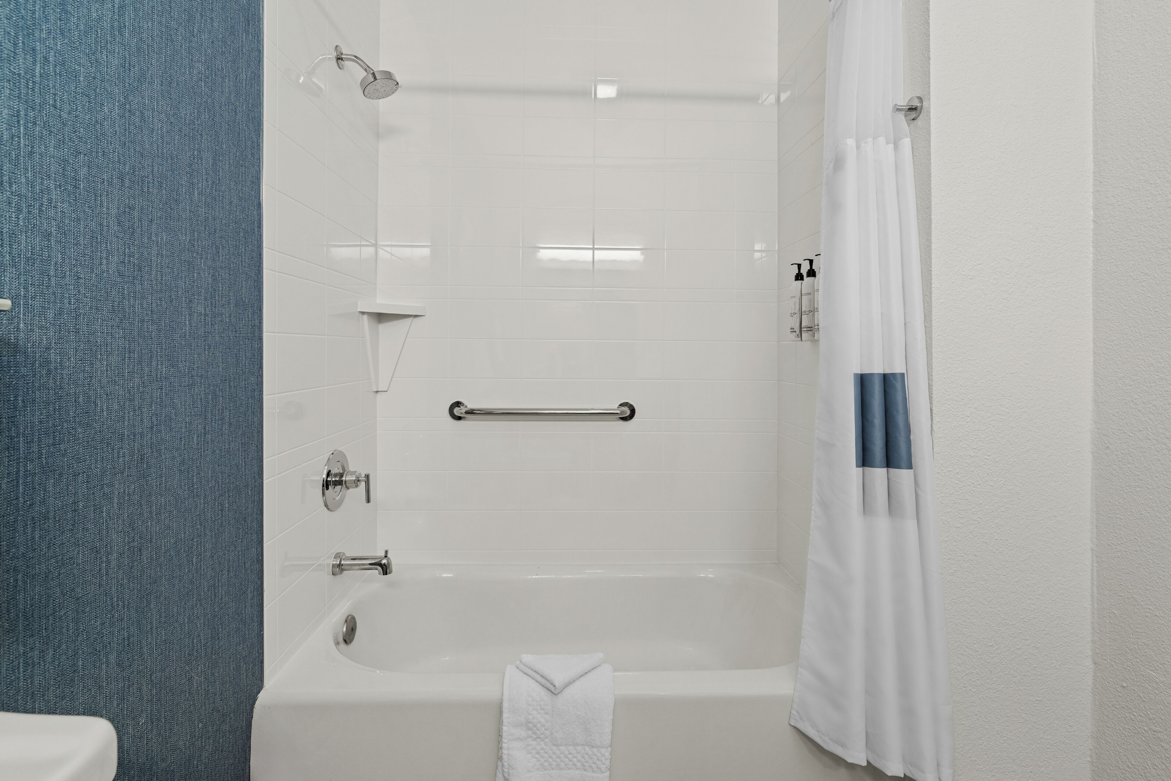 A bathroom with a bathtub, a shower, and a toilet.
