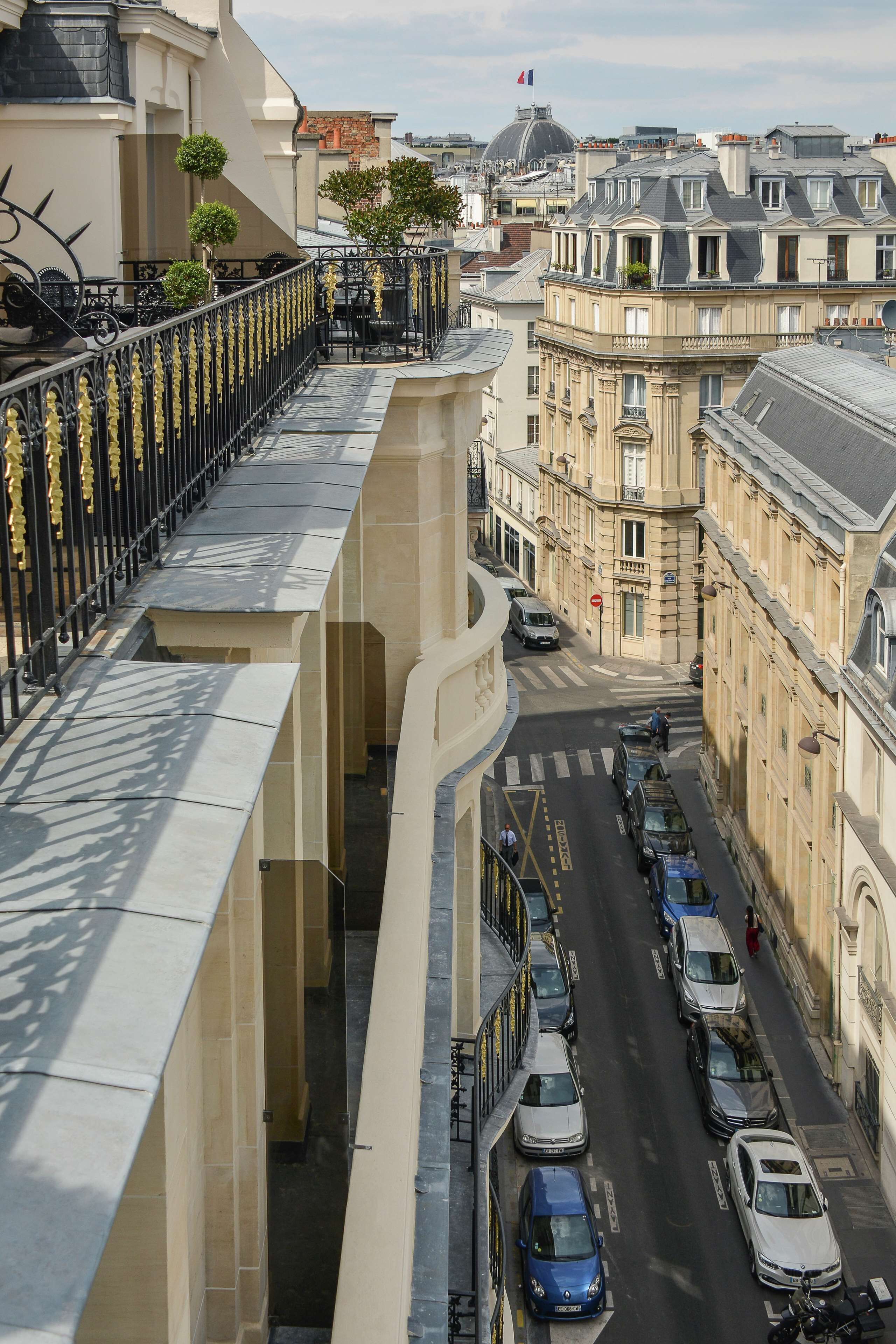 A street view with parked cars and buildings.