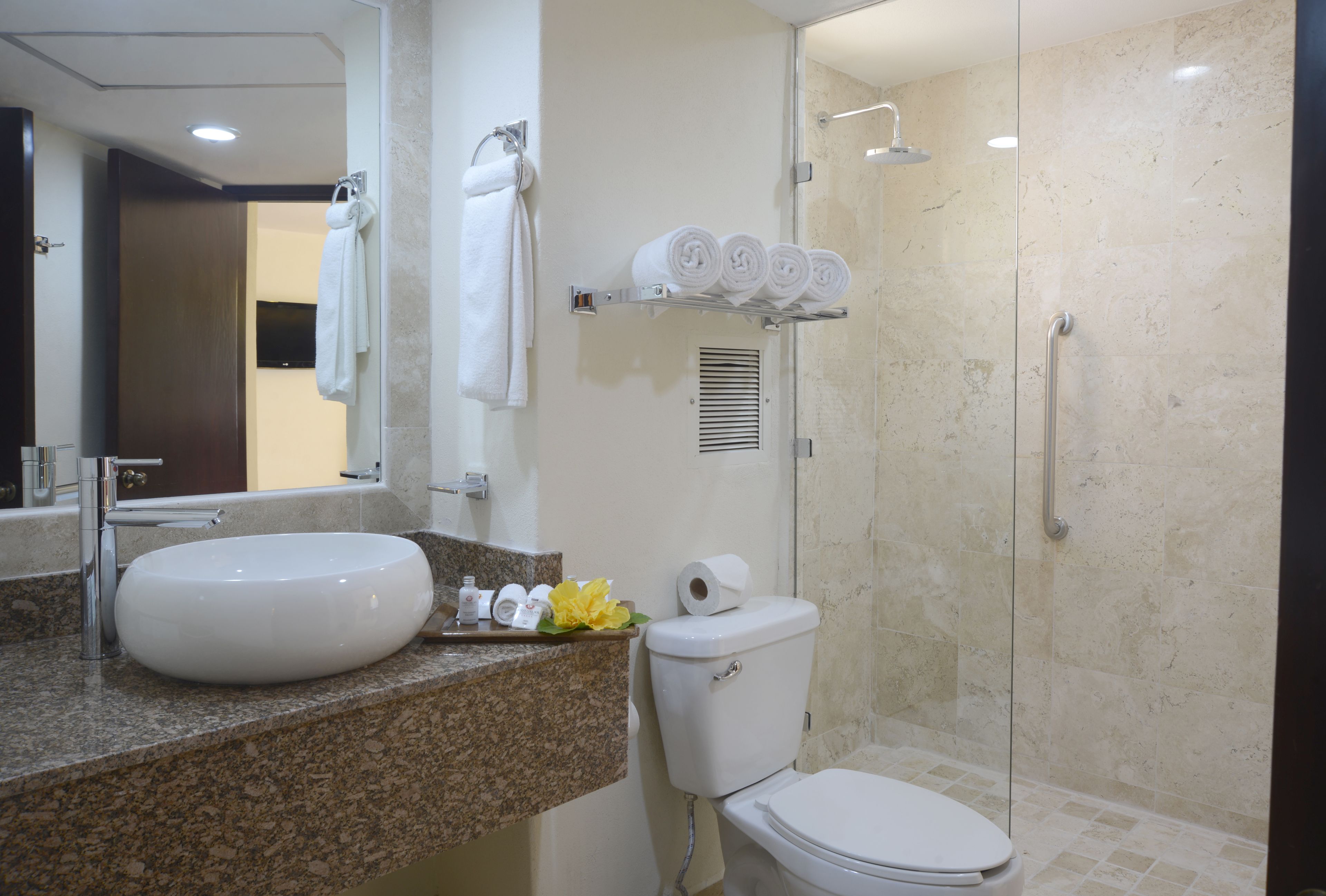 A bathroom with a sink, toilet, and shower.