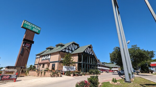 A building with a sign for 'Edelweiss Inn' and 'Jolt Drive Thru Coffee'.