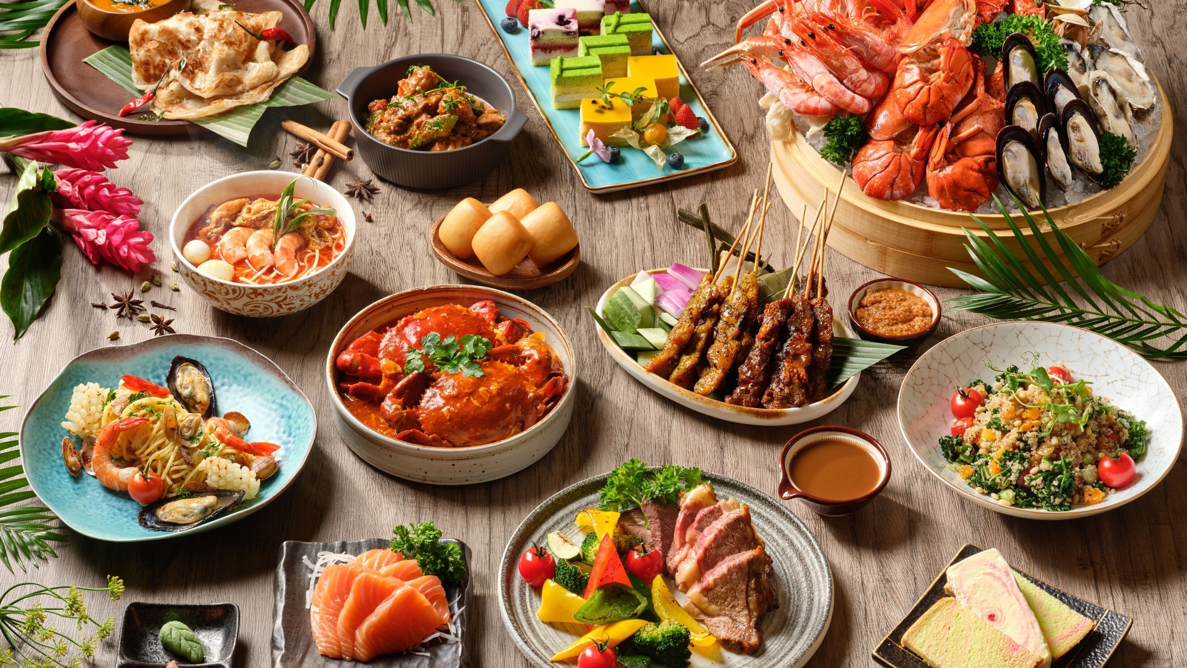 A variety of dishes including seafood, vegetables, and meats, arranged on a wooden table.