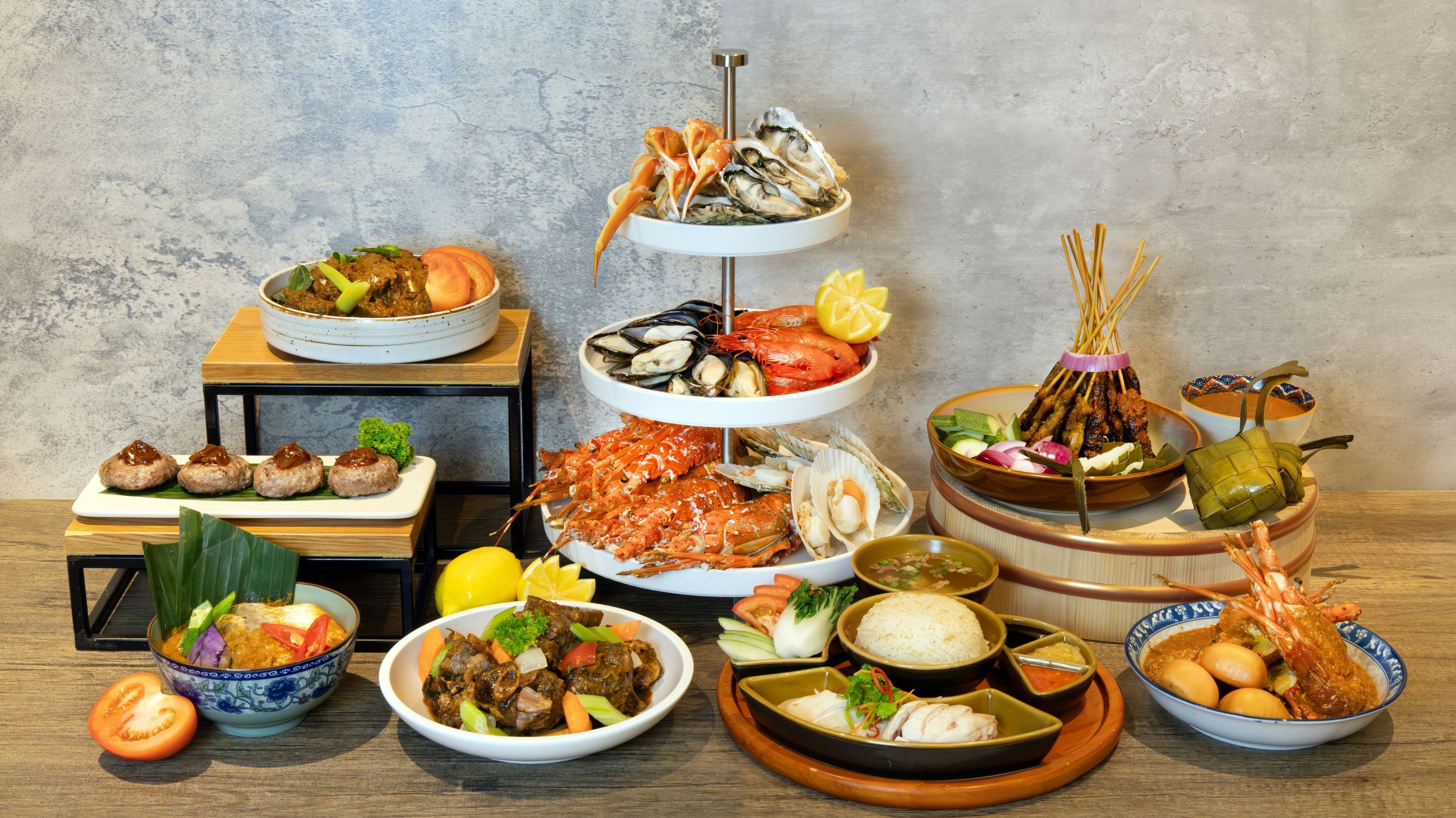 A variety of dishes arranged on a wooden table against a textured wall.
