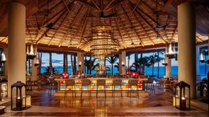 A spacious bar area with a view of the ocean, a thatched roof, and a central hanging light fixture. - One&Only Palmilla, Los Cabos (San José del Cabo)