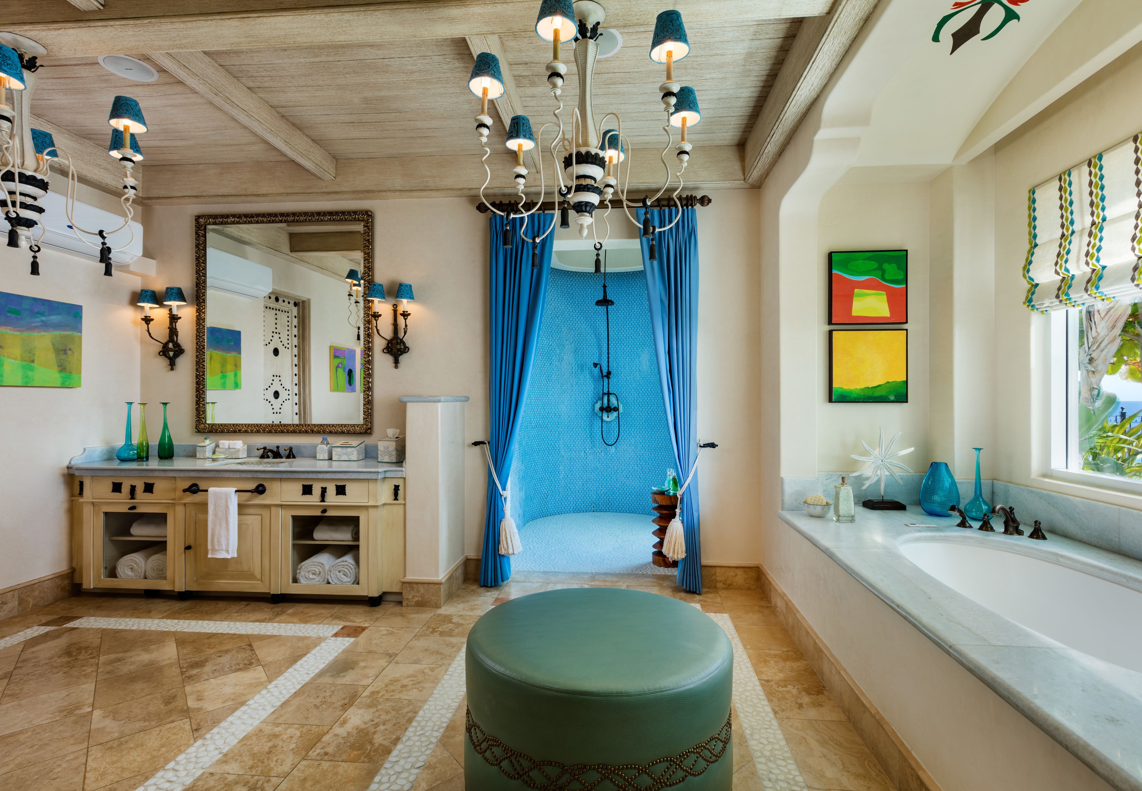 A bathroom with a large mirror, a bathtub, a sink, and a toilet.