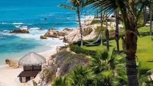 A beach with a thatched-roof hut, palm trees, and a hammock. - One&Only Palmilla, Los Cabos (San José del Cabo)