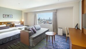 A hotel room with two beds, a sofa, a desk, and a view of the city. - Sapporo Excel Hotel Tokyu (Sapporo)