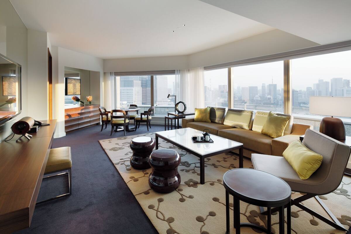 A modern living room with a sofa, coffee table, and chairs.