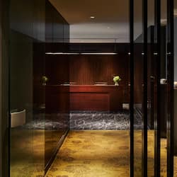 Welcome to our contemporary lobby, featuring a reception desk and comfortable seating area.