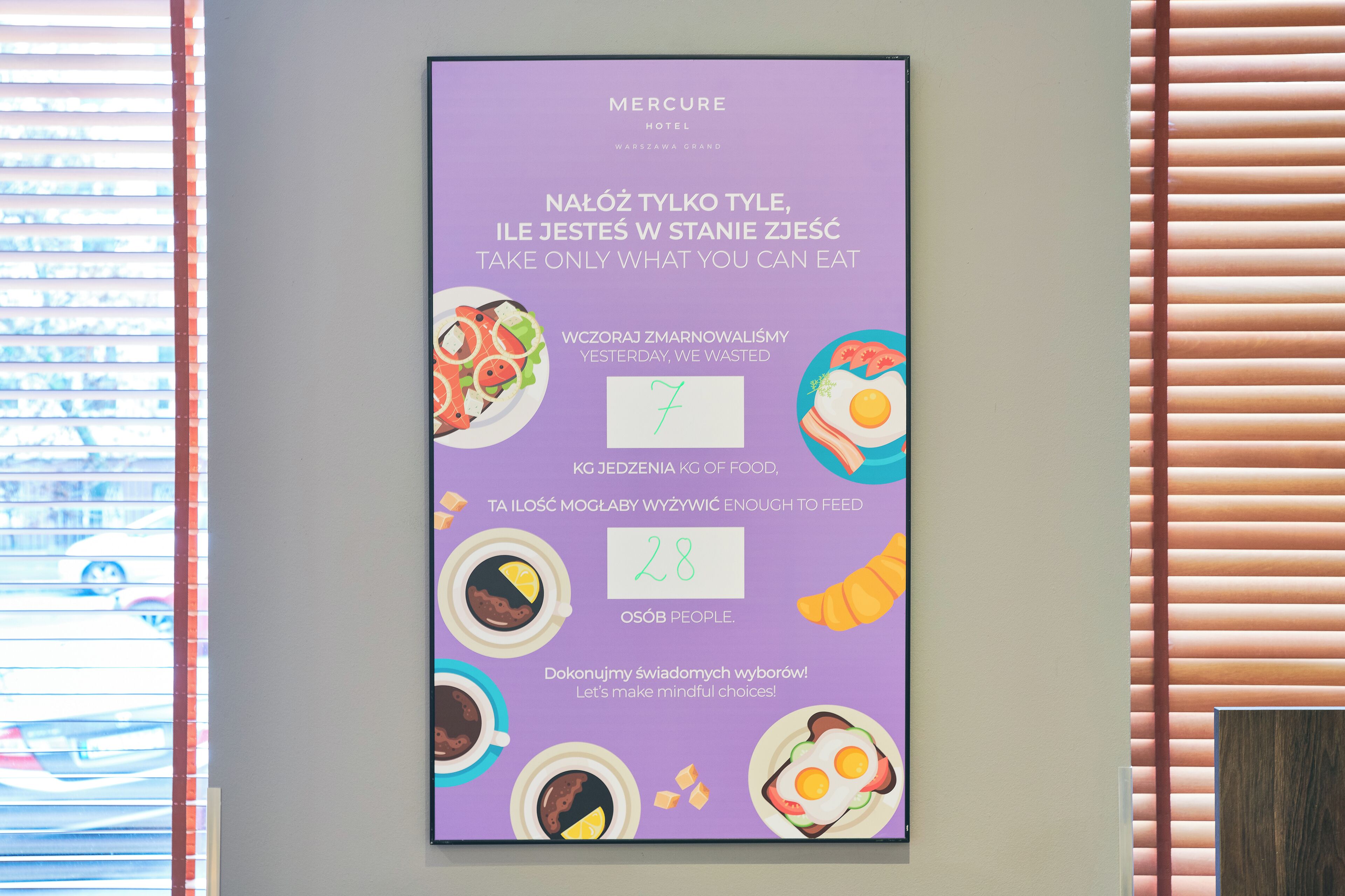 A poster on a wall with text and illustrations of food items, promoting mindful eating.
