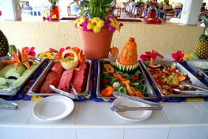 Enjoy a diverse spread of fresh fruits, vegetables, and salads at our buffet.