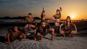 A group of people in animal print costumes on a beach at sunset. - Qualton Club Ixtapa - All Inclusive (Ixtapa)