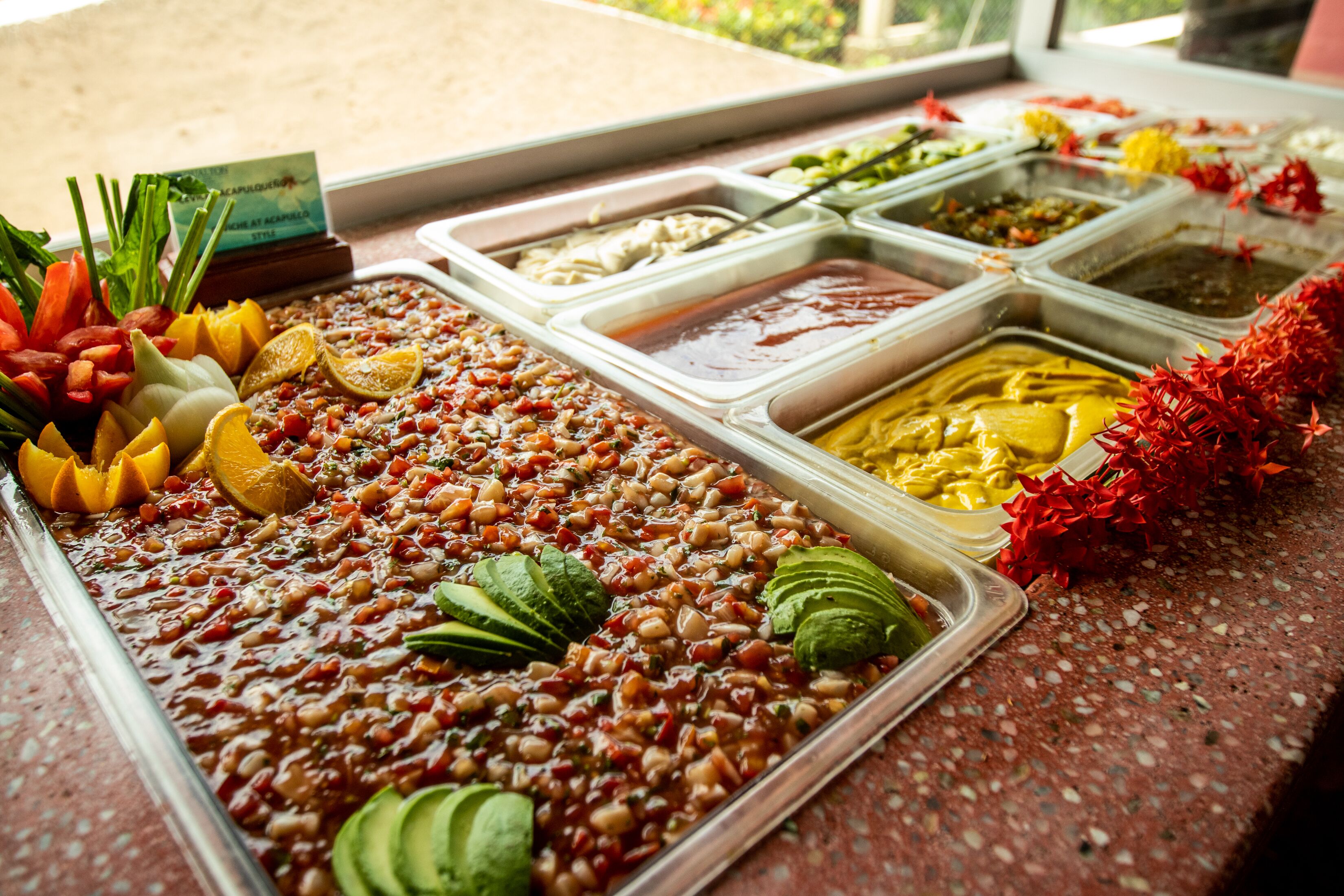 A buffet with various food items and garnishes.