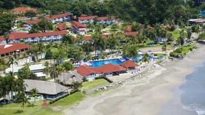An aerial view of a resort with multiple buildings, a swimming pool, and a beach. - Qualton Club Ixtapa - All Inclusive (Ixtapa)