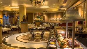 A buffet area with a variety of food options, a central decorative table, and a chandelier. - Peermont Walmont at Graceland, Secunda (Secunda)