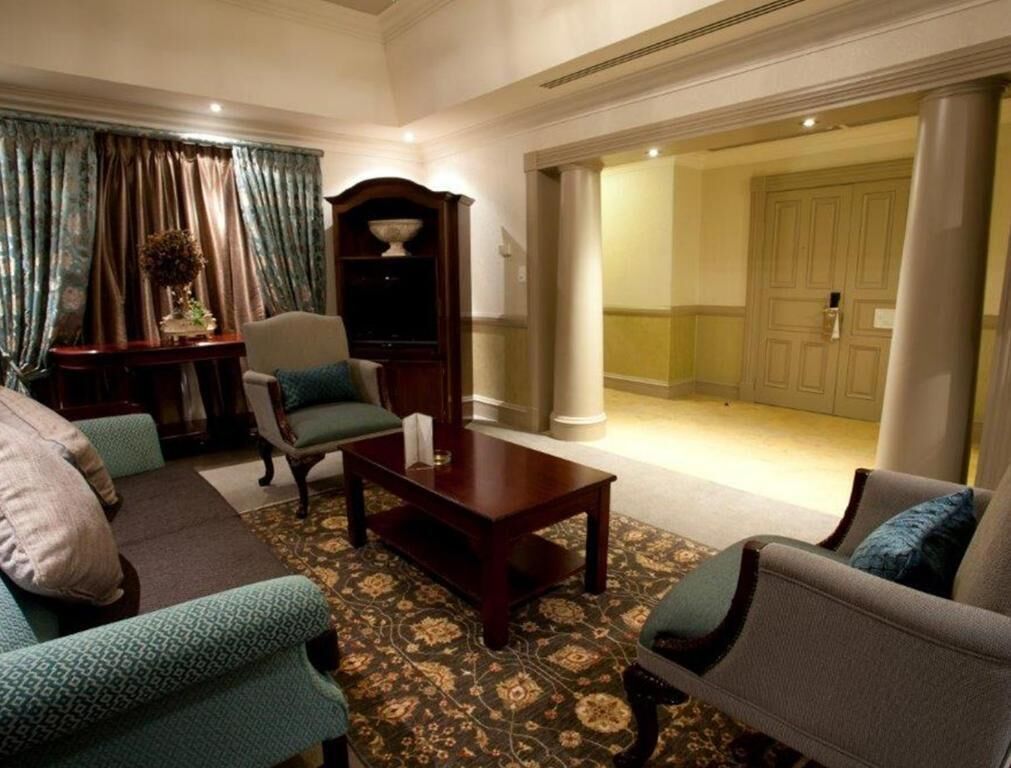 A spacious living room with a sofa set, a coffee table, and a decorative cabinet.