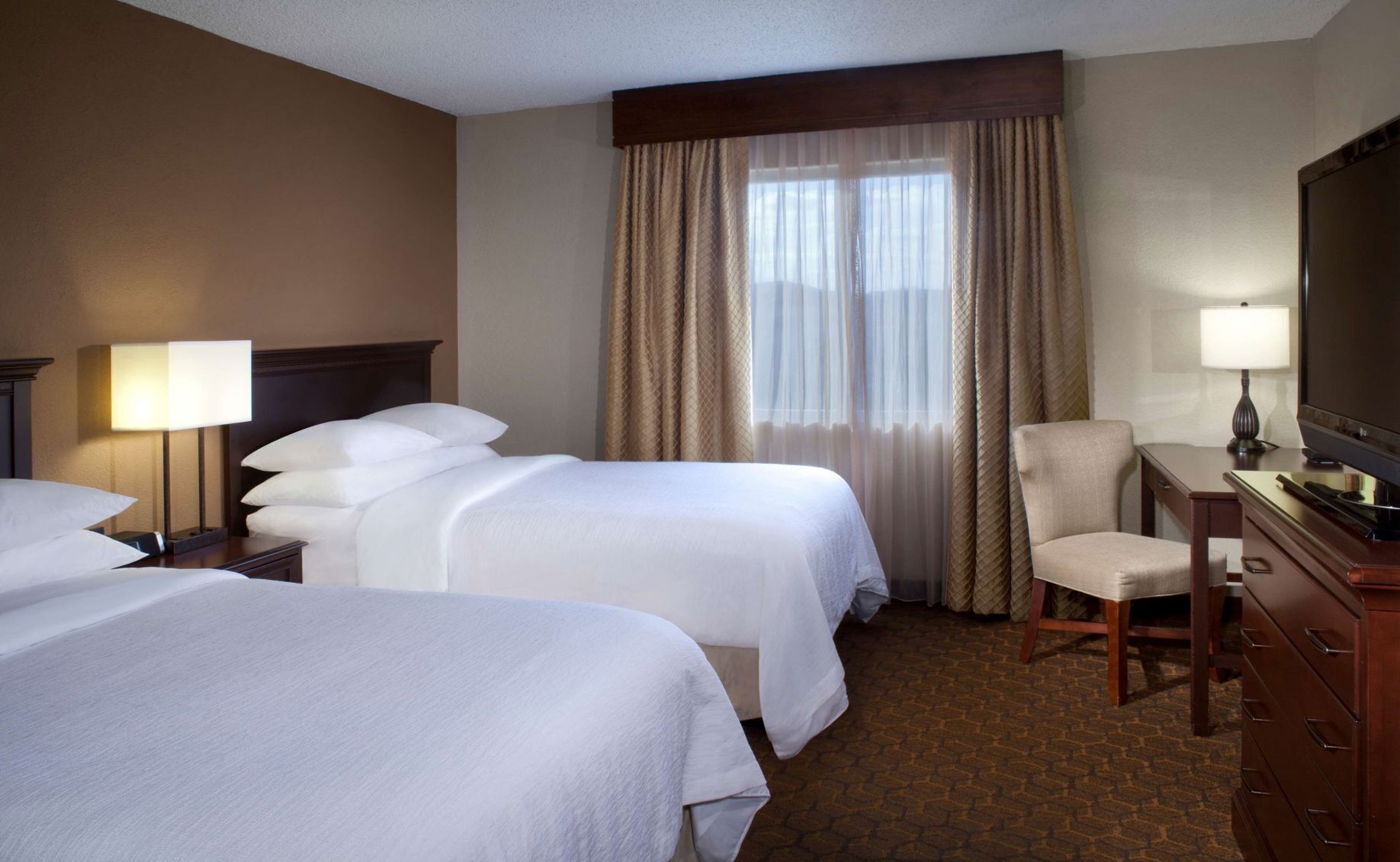 Premium bedding, down comforters, pillowtop beds, in-room safe