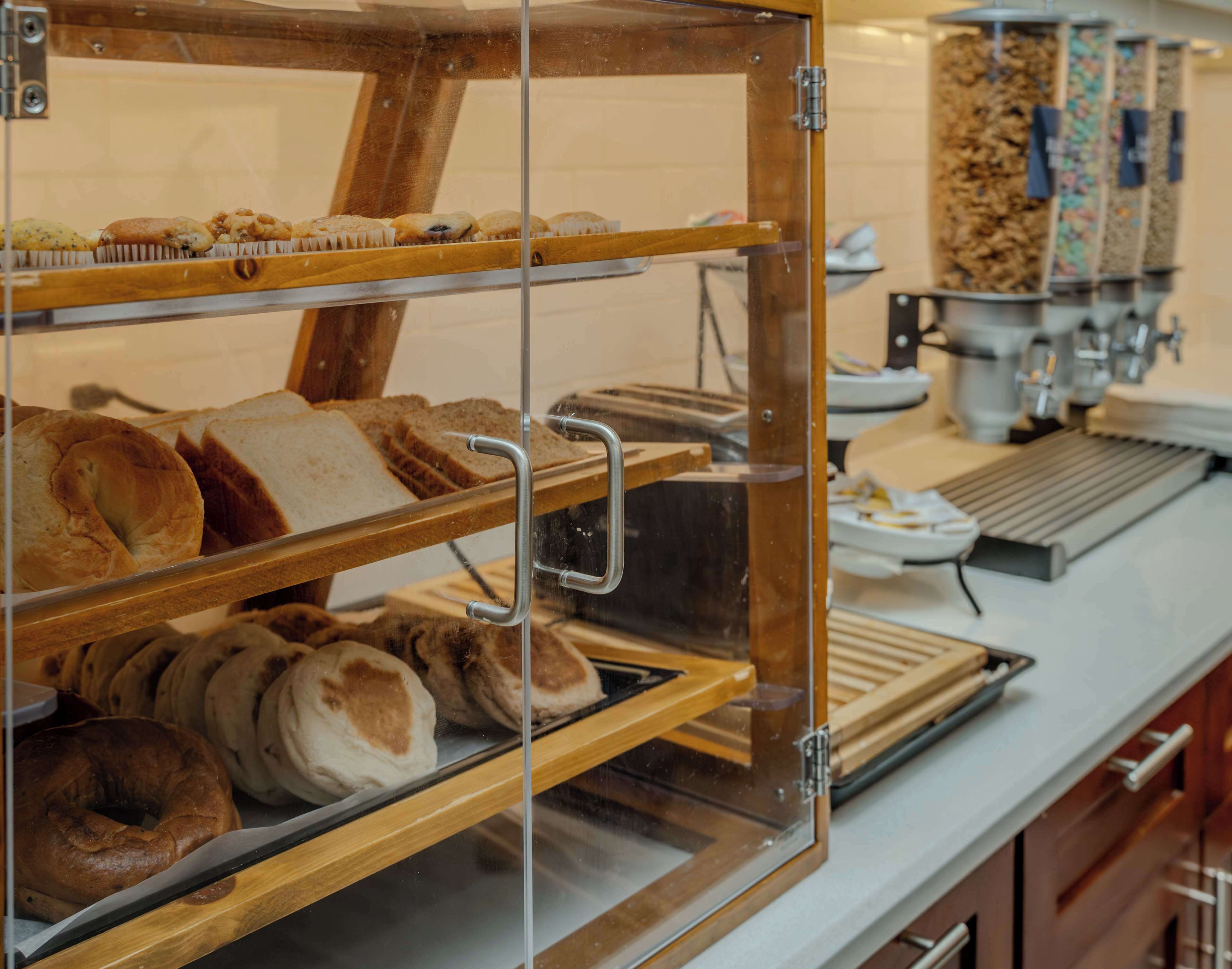 A bakery display case with various breads and pastries.