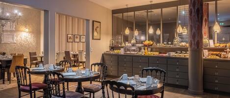 A dining area with round tables and chairs, a buffet counter with various food items, and a large pillar.