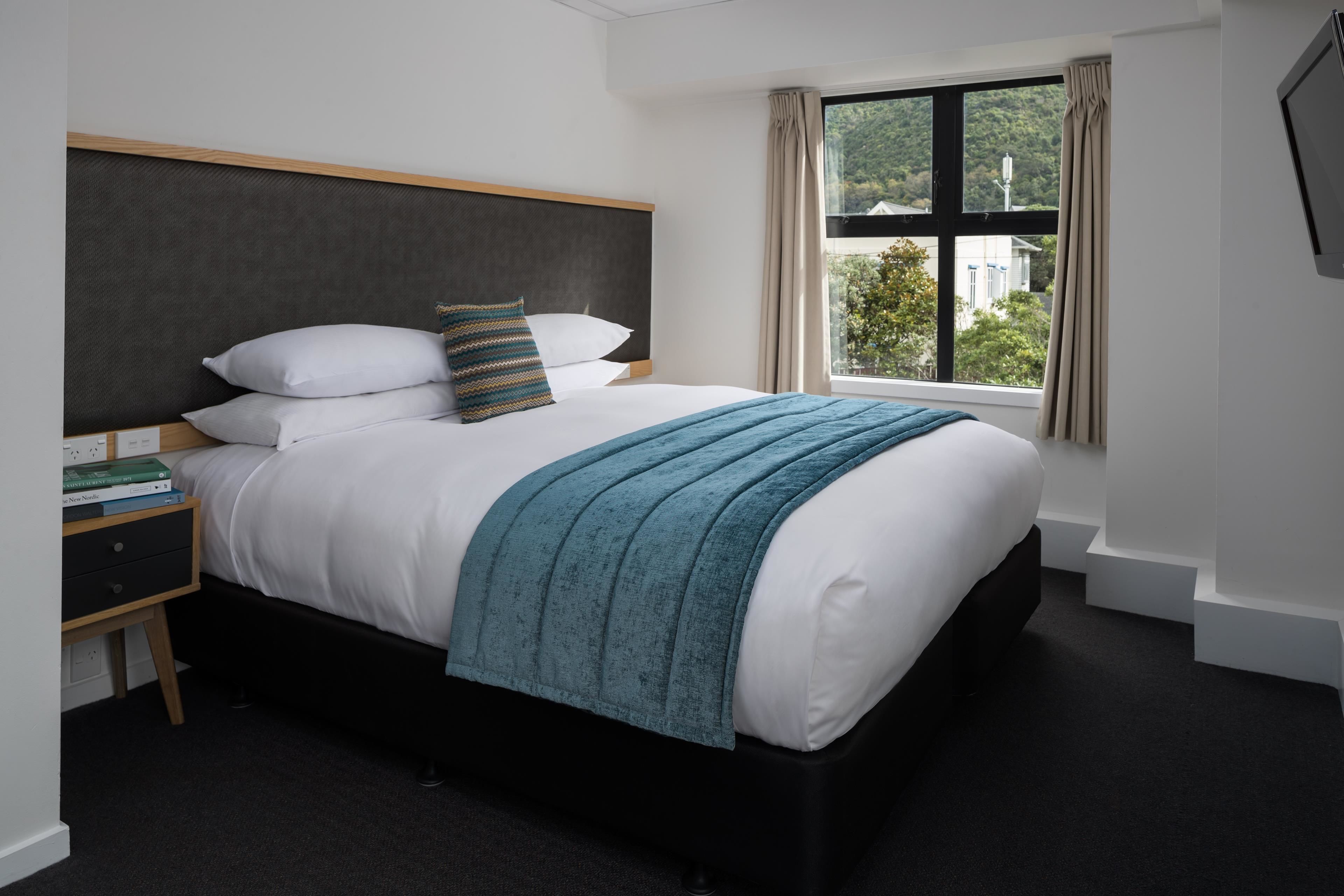 Hypo-allergenic bedding, desk, laptop workspace, blackout curtains