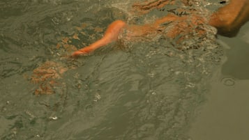 Una persona nadando en una piscina.